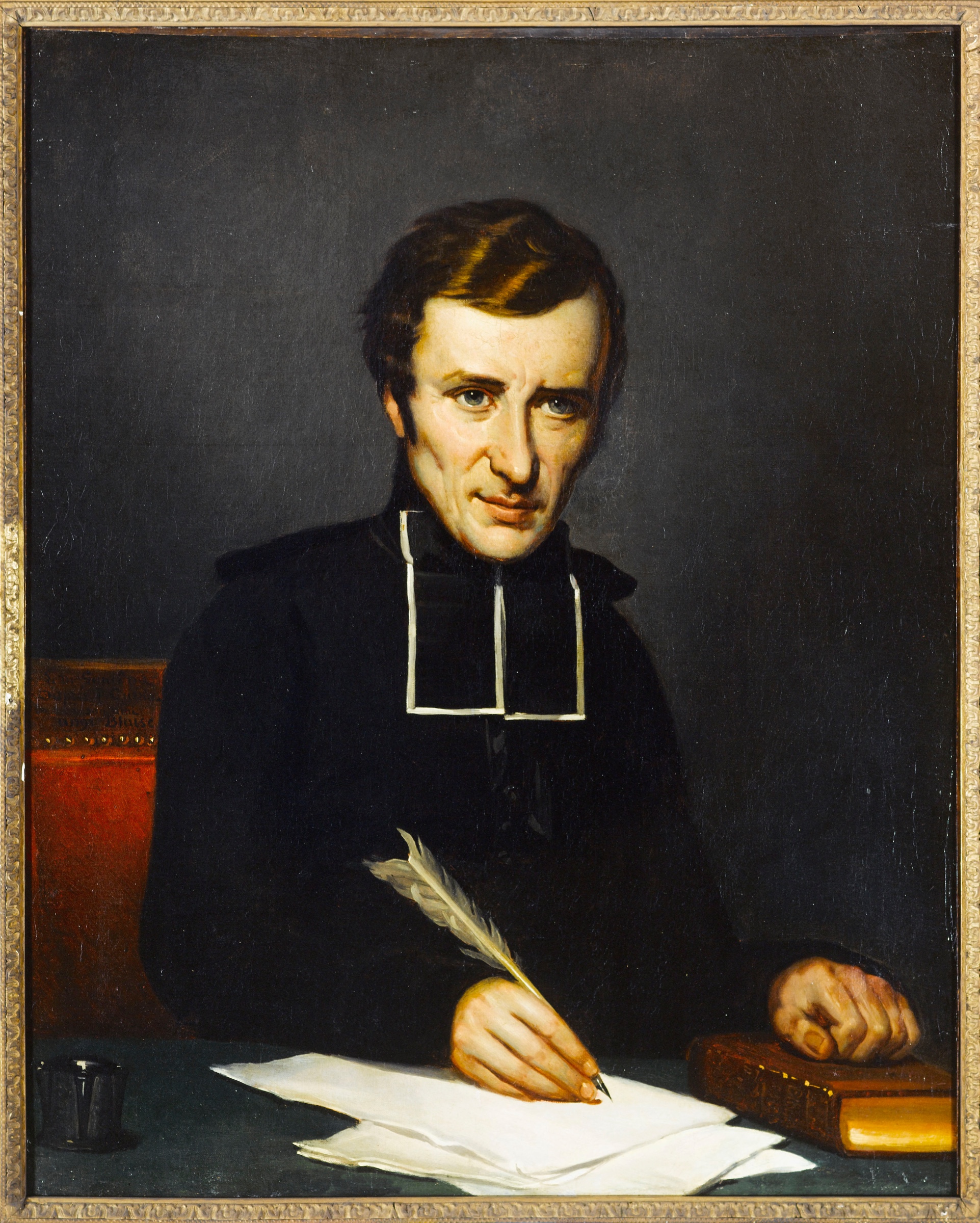 Portrait of Félicité de Lamennais seated at a writing desk with a quill in hand.